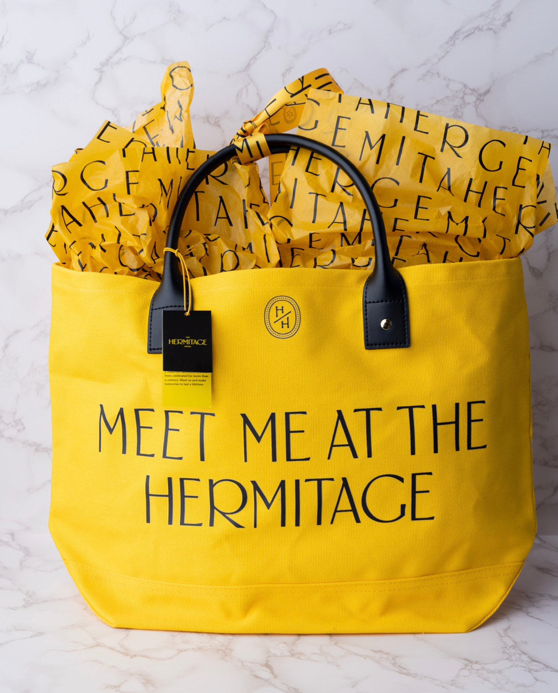 Yellow tote bag with a black handle